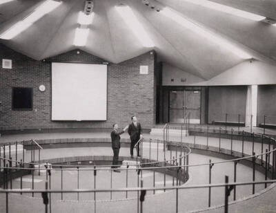 1969 photograph of the Education Building. Everett Samuelson and Thomas O. Bell inspecting the interior of the Kiva.