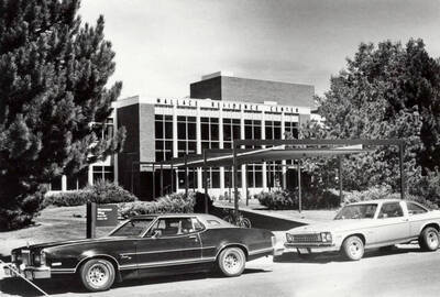 1970 photograph of the south entrance of the Wallace Residence Center. Automobiles in foreground.