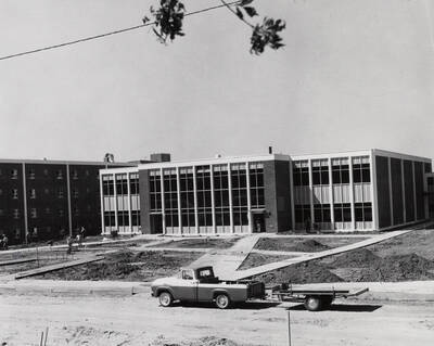 1963 photograph of the Wallace Residence Center under construction. Automobile in foreground. Donor: Publications Dept.