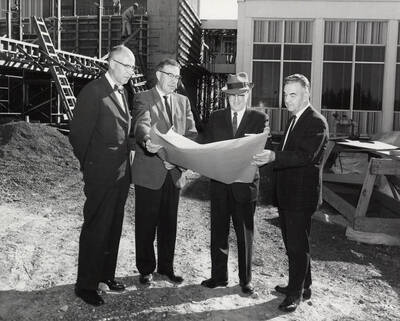 1963 photograph of the Wallace Residence Center under construction. Left to Right: President Theophilus, Kenneth A. Dick, Elvin Hampton, Robert F. Greene. Donor: Publications Dept.