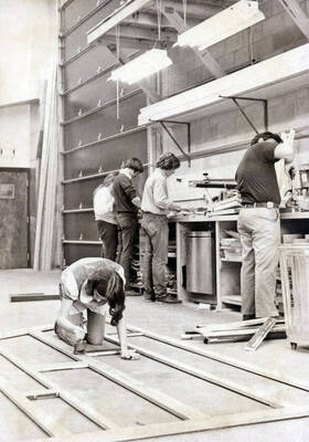 1975 photograph of Hartung Theatre. Students build set elements.
