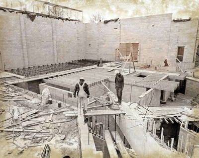 1974 photograph of the Hartung Theatre under construction. Construction workers in foreground.