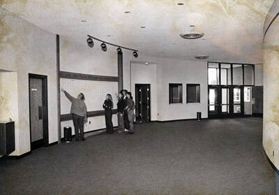 1974 photograph of the Hartung Theatre. Students stand in the lobby.