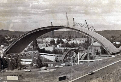 1975 photograph of the Kibbie-ASUI Activity Center under construction. Several large cranes in background.