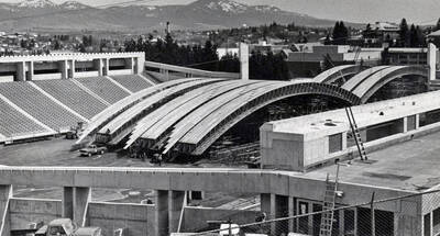 1975 photograph of the Kibbie-ASUI Activity Center under construction. Steam tower in background. Donor: U of I Alumni Office.