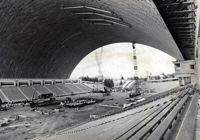 1975 photograph of the Kibbie-ASUI Activity Center under construction. Construction equipment in foreground. Donor: U of I Alumni Office.