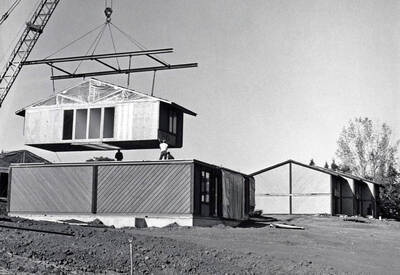 1970 photograph of the South Hill Terrace Apartments under construction. Construction workers in foreground.