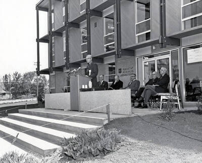 1963 photograph of the Forestry Sciences Laboratory dedication ceremony. Group of men in foreground. Donor: Publications Dept.