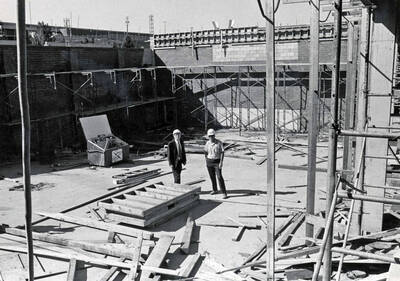 September 15, 1972 photograph of the Menard Law Building under construction. Left to right: A.R. Menard, Dick Benzel inspect the construction site.