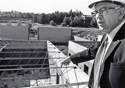 September 15, 1972 photograph of the Menard Law Building under construction. A.R. Menard pointing in foreground.