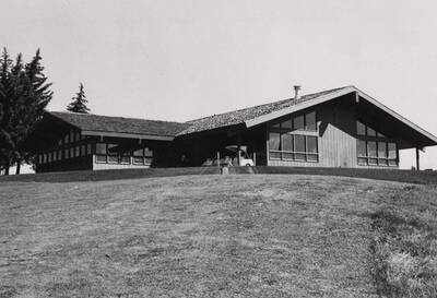 1970 photograph of the ASUI Golf Clubhouse. Golf cart in foreground.