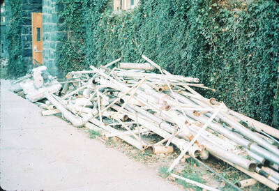 1975 photograph of Art and Architecture South during renovation. Detail of discarded pipe on the north side of the building. Donor: Karl Roenke and Robert Weaver, 1976.