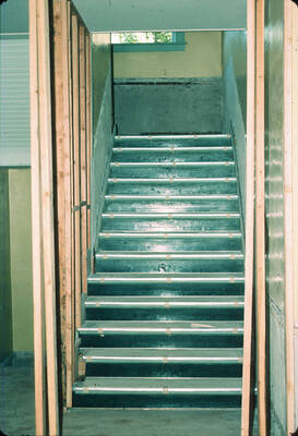 1975 photograph of Art and Architecture South during renovation. Detail of stairway in the north basement. Donor: Karl Roenke and Robert Weaver, 1976.