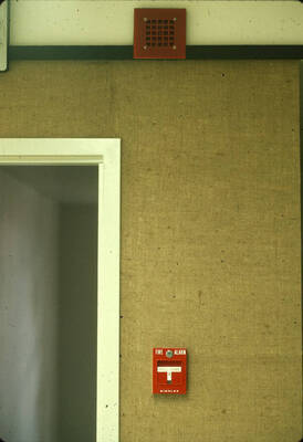 1975 photograph of Art and Architecture South during renovation. Detail of fire alarm handle and doorway. Donor: Karl Roenke and Robert Weaver, 1976.
