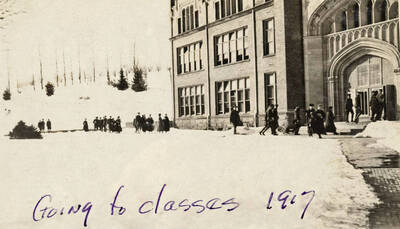 1917 photograph of University of Idaho campus. Students enter the administration Building for classes. Donor: G. Fallquist.