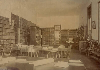 1904 photograph of the Library. Reading desks in foreground, stacks in background. Donor: W.C. Edmundson.