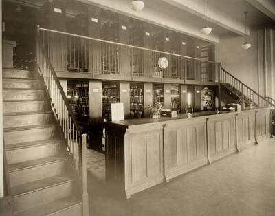 1922 photograph of the Library. Closed stacks behind desk.