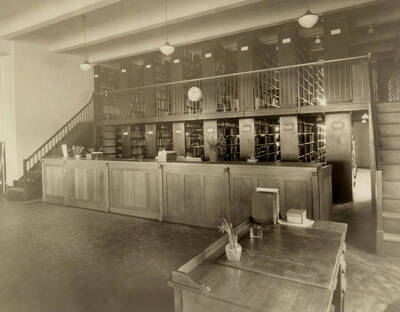 1922 photograph of the Library. Closed stacks behind desk.
