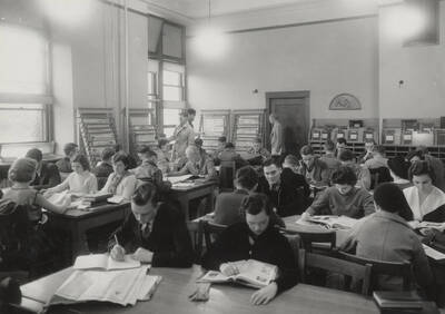 1934 photograph of the Library. Students read near periodicals collection.