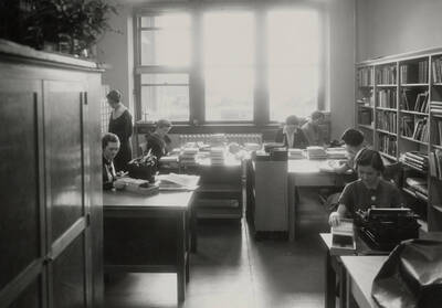 1934 photograph of the Library. Library employees work behind the scenes.