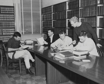 1961 photograph of the Law Library. Students studying in foreground. Donor: Photo Center.
