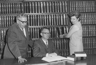 1961 photograph of the Law Library. Left to right: Thomas R. Walenta, George M. Bell, Carolyn Folz.