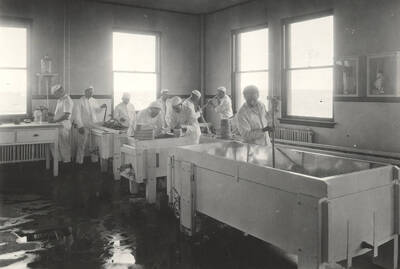 1925 photograph of Dairy Farm and Creamery. Students make cheese in a classroom.