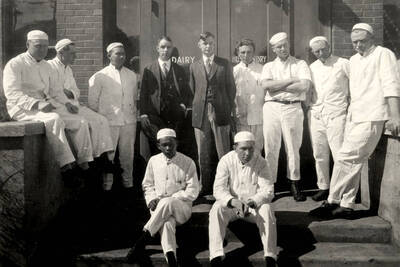 1925 photograph of Dairy Farm and Creamery. Students and instructors of the Creamery Course pose for a photograph on the steps of the Creamery building.