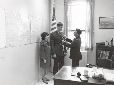 1960 photograph of Air Force Officer Education Program. A medal pinning ceremony