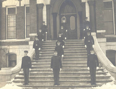 1905 photograph of Military Science Cadets. Battalion officers in formation on the steps of the old Administration building.