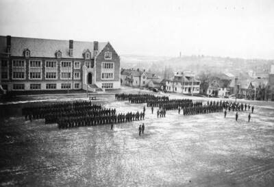 1925-12-05 photograph of Military Science Cadets. ROTC regiments in formation in front of Science building.