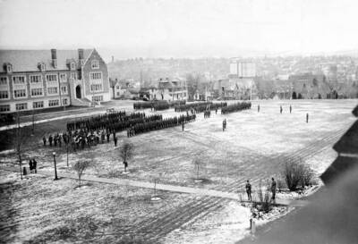 1925-12-05 photograph of Military Science Cadets. ROTC regiment in parade formation in front of Science building.