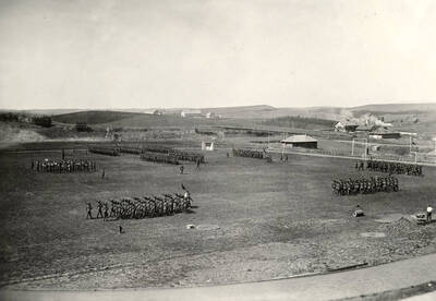 1926-04-24 photograph of Military Science Cadets. Military cadets in parade formation on MacLean field.