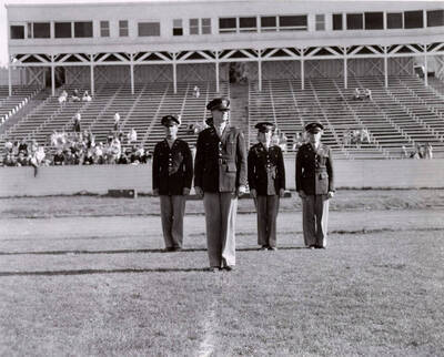 1953 photograph of Military Science Cadets. ROTC regimental staff standing on MacLean field.