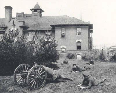 1914 photograph of Military Science Cadets. Six military cadets participate in field exercises on campus.