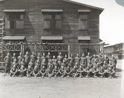 1924 photograph of Military Science Cadets. Cadet officers lined up in front of a building at Camp Lewis.