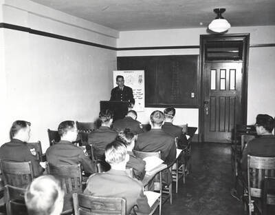 1951 photograph of Military Science Cadets. Military cadets sitting in a classroom during a lecture.