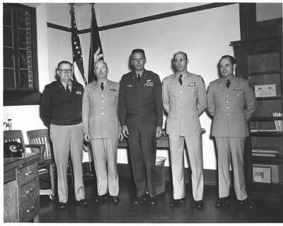 1951 photograph of Military Science Cadets. Inspection team l-r: C.F. Hudson, C.H. Bragg, F.M. Pliniau, D. Tarallo, J.R. George.