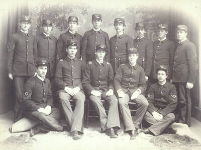 1897 photograph of Military Science Cadets l-r: (front) E. Mautz, W.E. Stillinger, G. Snow, R. Hattabaugh, J. Boyd; (back) J. Burke, J. Herman, B.E. Bush, S. Knudson, M. Reed, H. Estes, J.E. Jewell, E. Armstrong.neg envelope has two negs: one of whole group, one close-up of back row, right side. Portrait of Company 'B' officers. Donor: UofI Army ROTC.