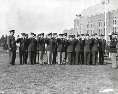 1953 photograph of Military Science Cadets. Col. Blewett giving oath of enlistment to cadets who joined Moscow reserve units. Donor: Publications Dept.
