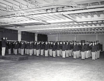 1953 photograph of Military Science Cadets. Class of 1953 cadets receiving oath from Major Woods.