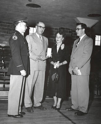 1953 photograph of Military Science Cadets l-r: A.E. Blewett, Mr. And Mrs. Lin I. Ellis, Evan Ellis.Also print. Donor: Army ROTC.