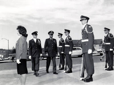 1962 photograph of Military Science Cadets. l-r: Cadet Capt. Patsy McCullough, Cadet 2nd Lt. Eimers, Lt. Gen Ryan, Cadets Knudsen, Schaufelberger, McFarland, Wales. Donor: Army ROTC.