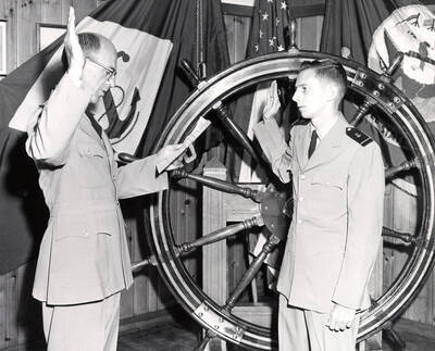 1962 photograph of Naval Science. Captain Davey commissioning Eddie Whitehead. Donor: Publications Dept.