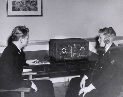 1948 photograph of Naval Science. Naval Science Cadets operate a transceiver. Donor: Publications Dept.