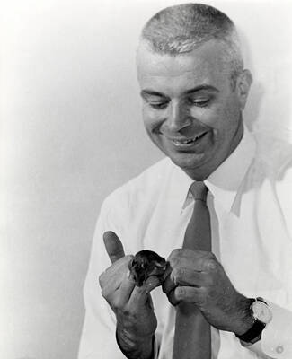 1964 photograph of Zoology building. View of Professor and lab animal.