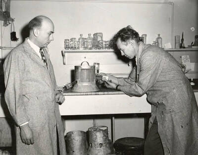1948 photograph of Agricultural chemistry building. Professors work in the lab.
