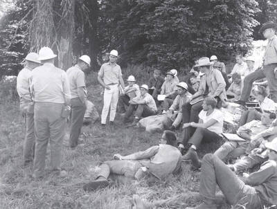 1966 photograph of College of Forestry. Students sitting on a hillside during the forestry summer camp. Also print. Donor: Fred Johnson.
