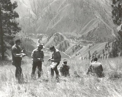 1969 photograph of College of Forestry. Lee Sharp and students at Allison Creek during the forestry summer camp. A mountain and stream are visible in the background. Also print. Donor: Fred Johnson.
