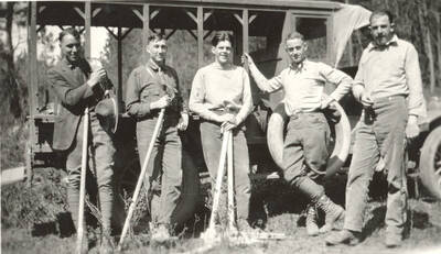 1923 photograph of College of Forestry. Five forestry students stand in front of a vehicle during a field trip.